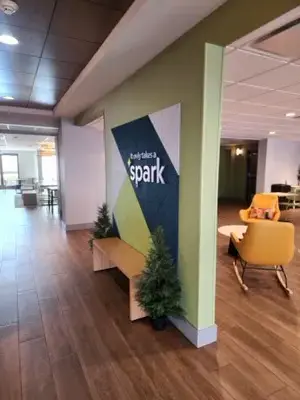 Spark by Hilton lobby with branded arrival wall renovation